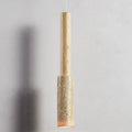 Cream travertine tube pendant light hanging against a grey wall