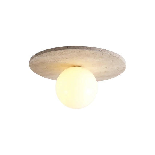 Tanner Essence travertine ceiling light, stone disc with an opal globe, product view