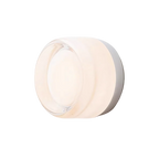 Dusk-to-dawn glass wall sconce, white dimple version on a pale backdrop