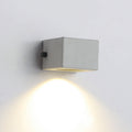 Cement square outdoor wall light, cube version casting a downward glow, close view