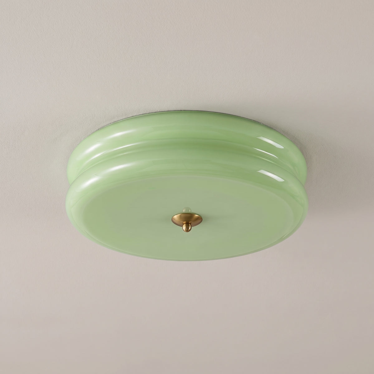 Aurelio glass flush mount ceiling light, green shade with brass finial, studio shot on a neutral backdrop