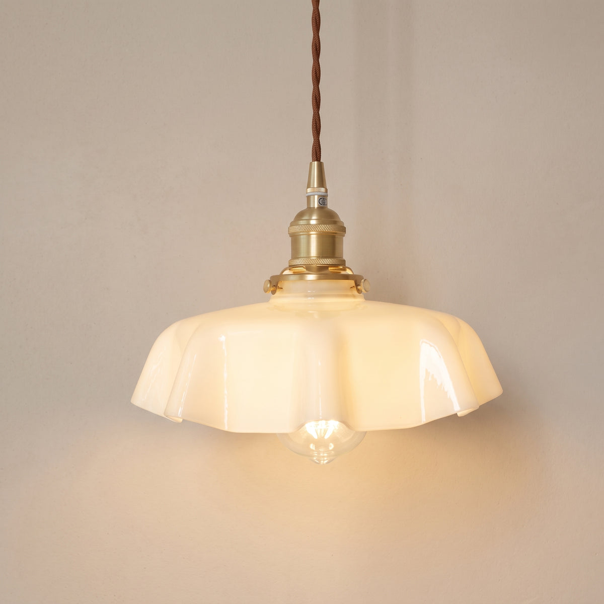Vintage opaline glass pendant light, cream ruffled shade, studio shot on a neutral backdrop