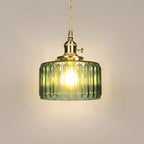 Celeste glass pendant light, pale green ribbed drum with brass switch socket, studio shot on a neutral backdrop
