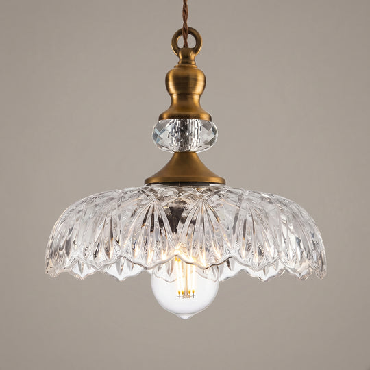 Clarionne engraved glass pendant light, brass fittings and clear cut shade, studio shot on a neutral backdrop