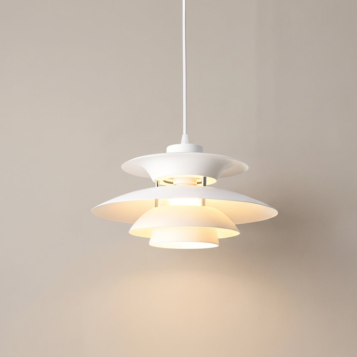 Aurora Stillness tiered pendant light in white, studio shot on a neutral backdrop