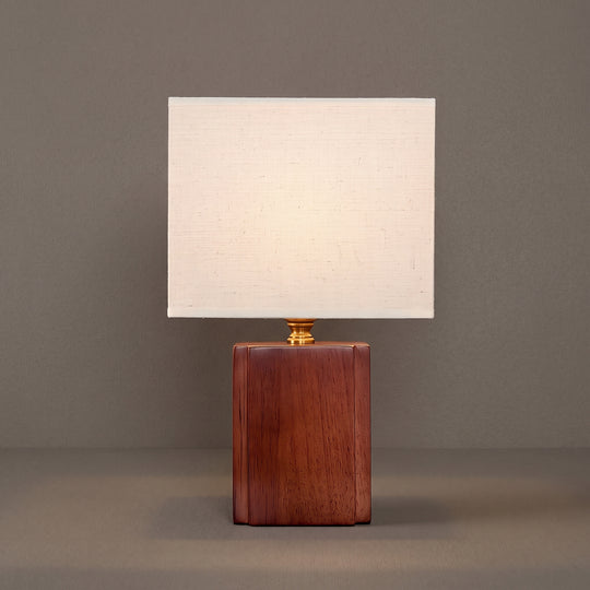Kairo linen table lamp, rectangular cream shade on a walnut-tone block base, studio shot on a neutral backdrop