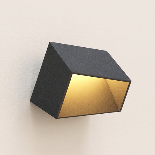Cube garden light, dark grey angled box glowing warm inside, studio shot on a neutral backdrop
