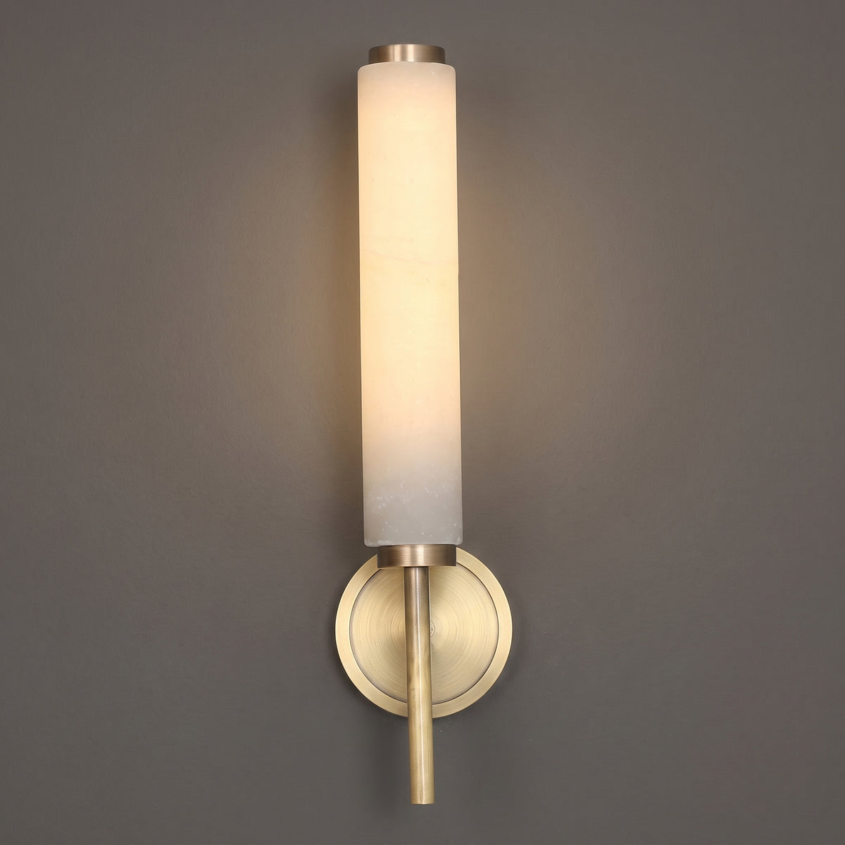 Marble tube wall sconce, single head in gold, studio shot on a neutral backdrop