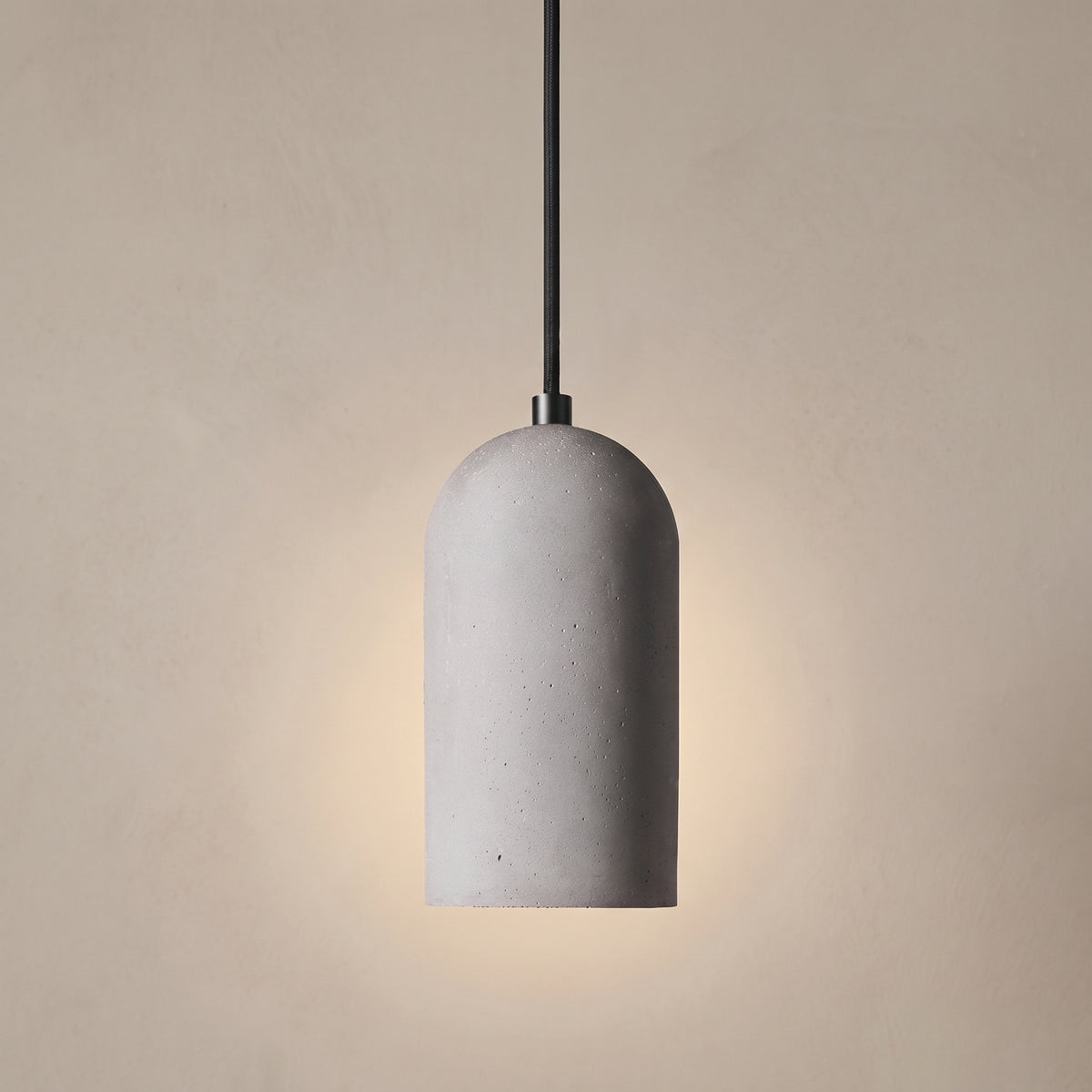 Minimalist cement pendant light, studio shot on a neutral backdrop