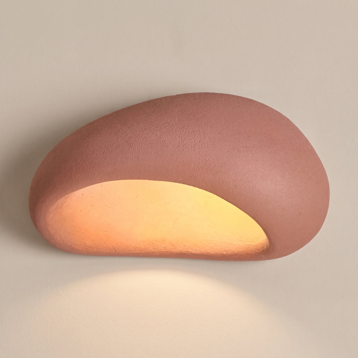 Wabi Sabi pebble ceiling light, terracotta red shade, studio shot on a neutral backdrop