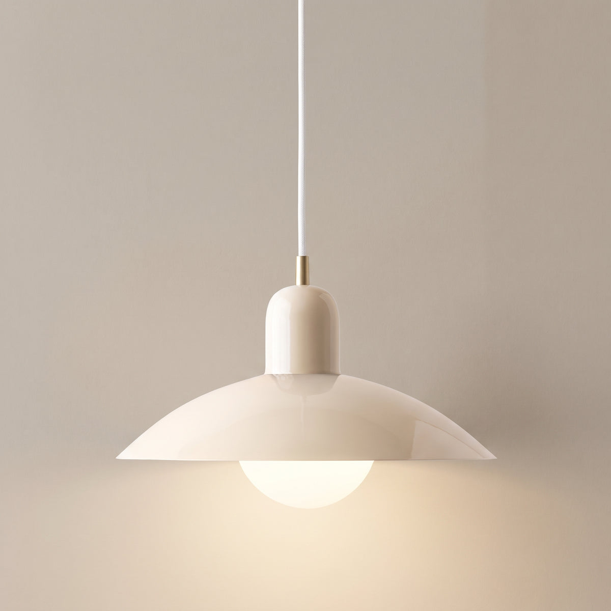 Macaron pendant light, cream shade and white cup, studio shot on a neutral backdrop