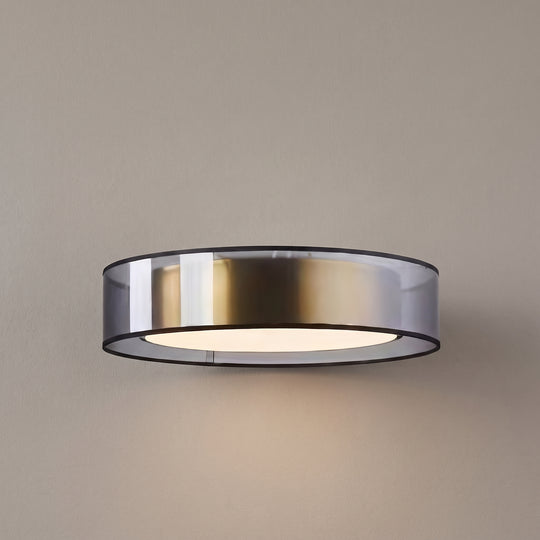 Rosé glass ceiling light, smoked drum with brass inner band, studio shot on a neutral backdrop
