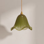 Verdantia green glass flower pendant light, olive bell shade with ruffled rim, studio shot on a neutral backdrop