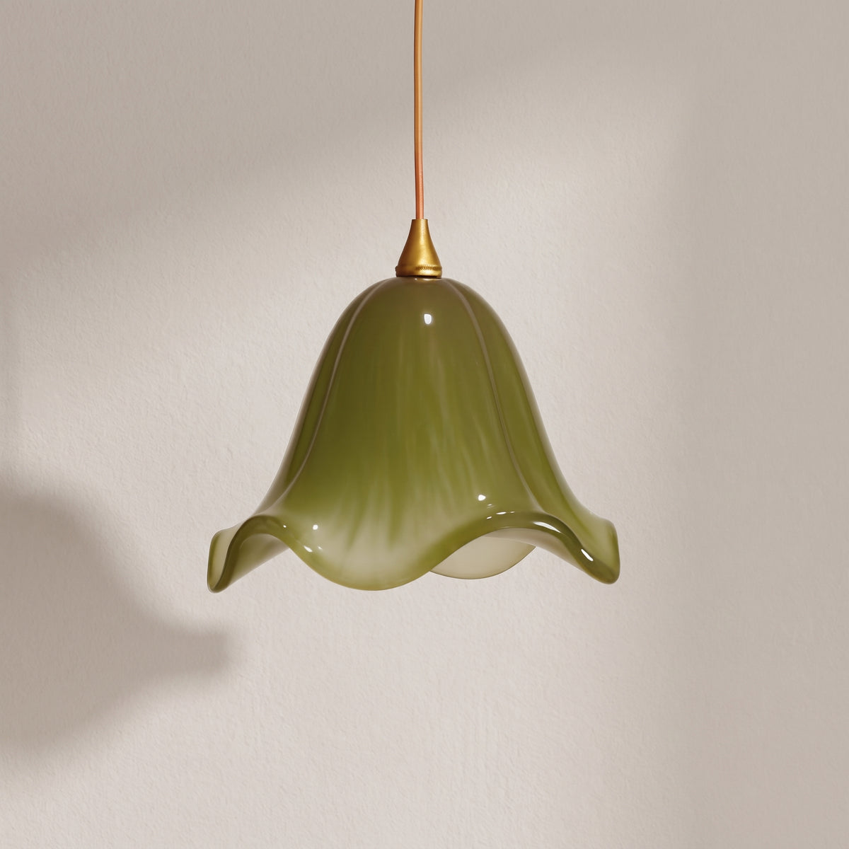 Verdantia green glass flower pendant light, olive bell shade with ruffled rim, studio shot on a neutral backdrop
